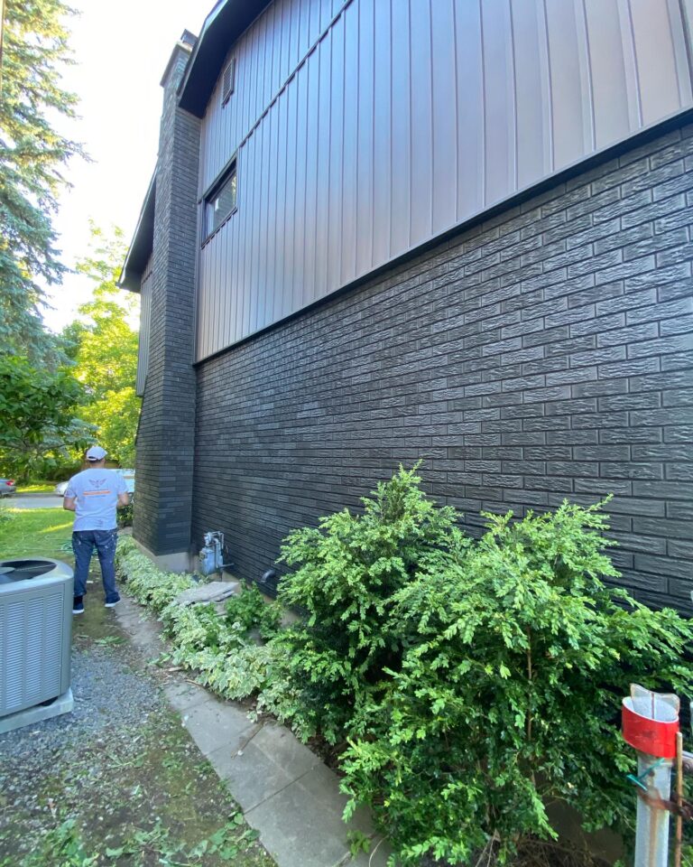 Ottawa exterior painters applying paint to house siding