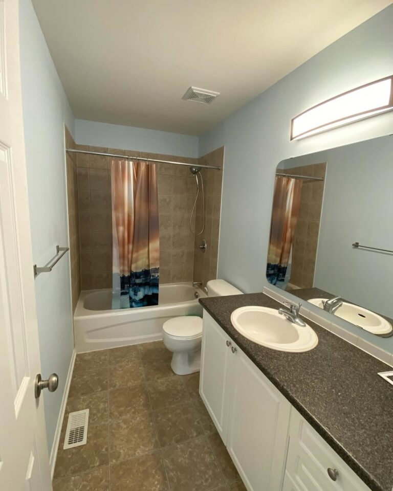 Residential bathroom freshly painted in soft blue with white trim in Ottawa.