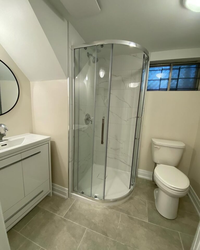 Bathroom interior with warm taupe walls and new lighting fixture painted by professional Ottawa painters.