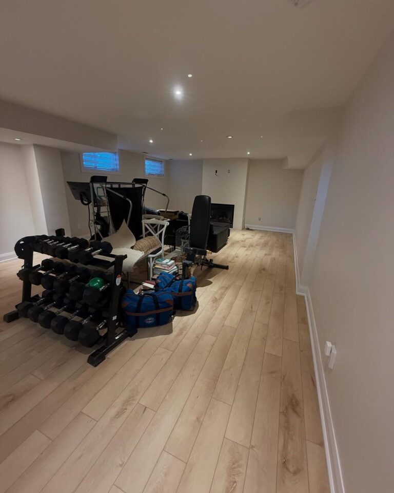 Residential basement painting in Ottawa for a home gym and multipurpose living space.