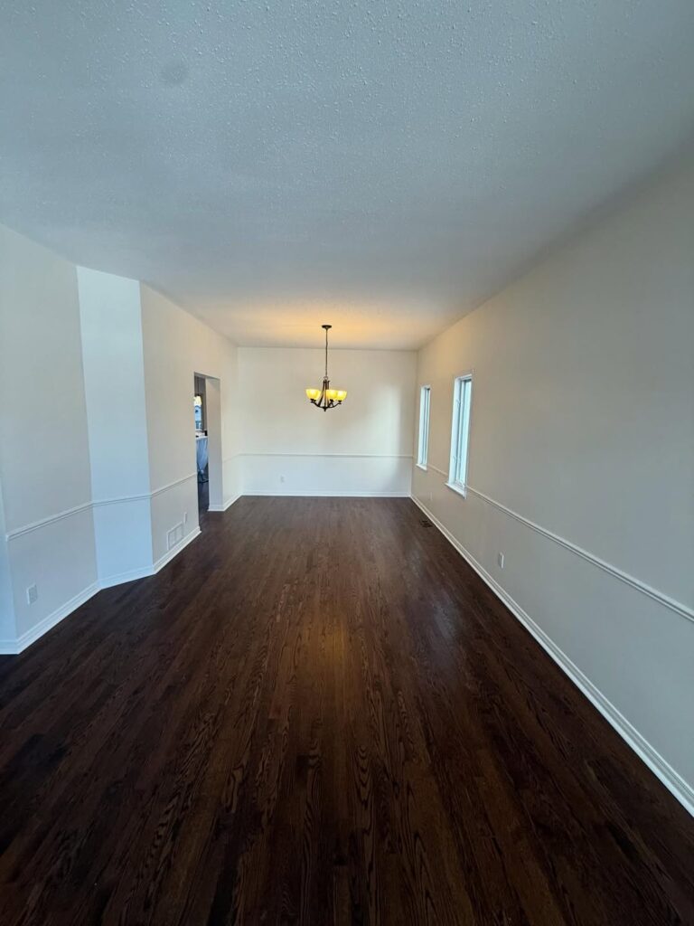 Professional dining room painting Ottawa featuring clean white wainscoting and modern neutral walls.